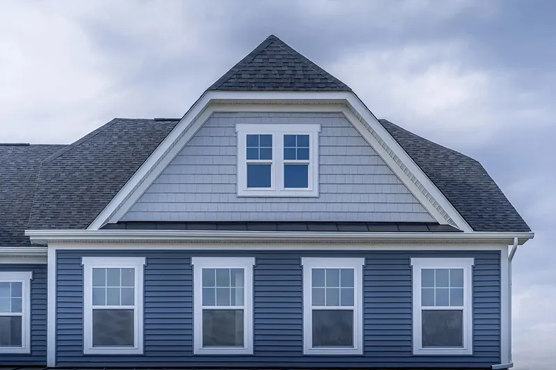 Two-story home with blue siding and new white double-hung windows
