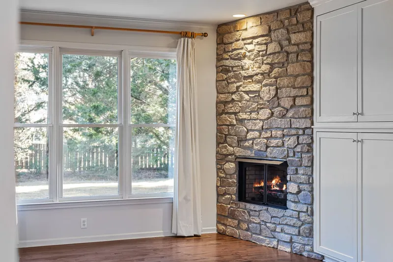 Bright living room with a fireplace and new windows