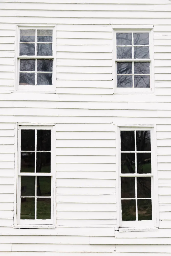 Weathered old wood windows with peeling paint