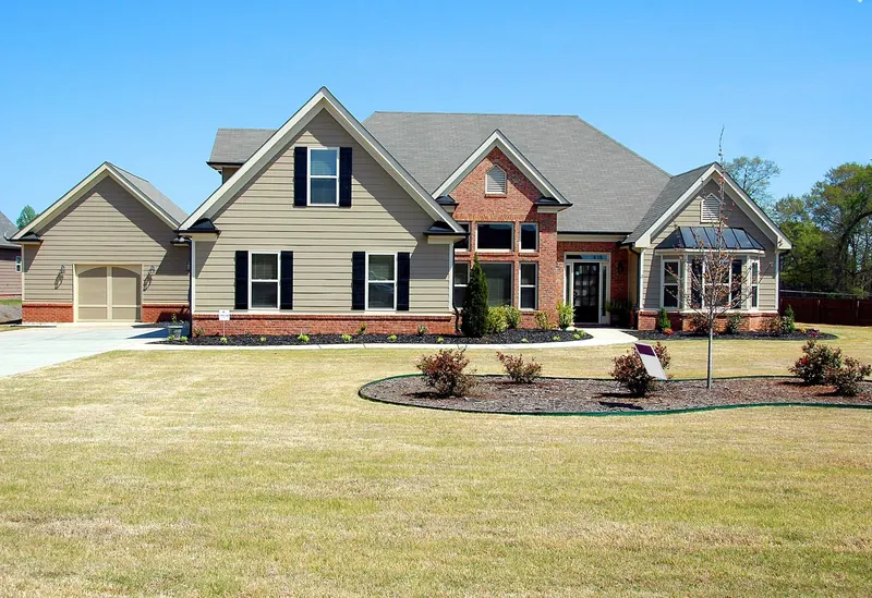 Brick and tan ranch home with new white windows and black shutters